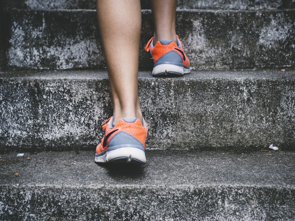 On her way — sneakers taking the stairs