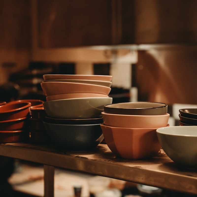 Warm earthenware bowls on a kitchen shelf